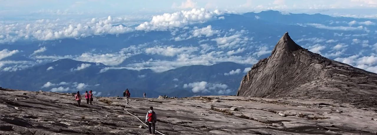 People climbing mountain with sky view