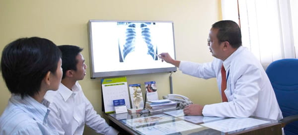 Doctor pointing at lung x-ray